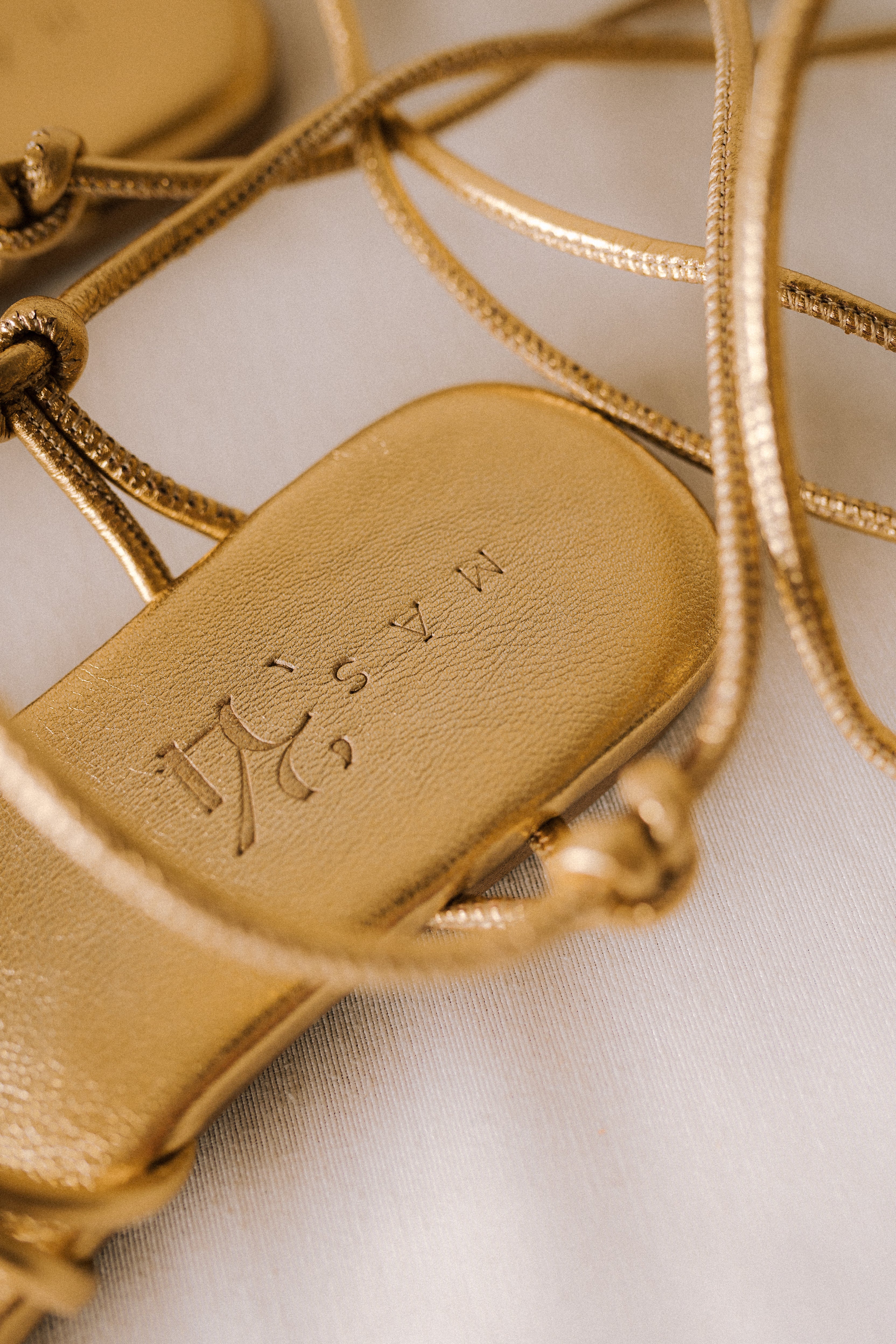 CATY FLAT SANDAL IN GOLD LAMINATED LEATHER