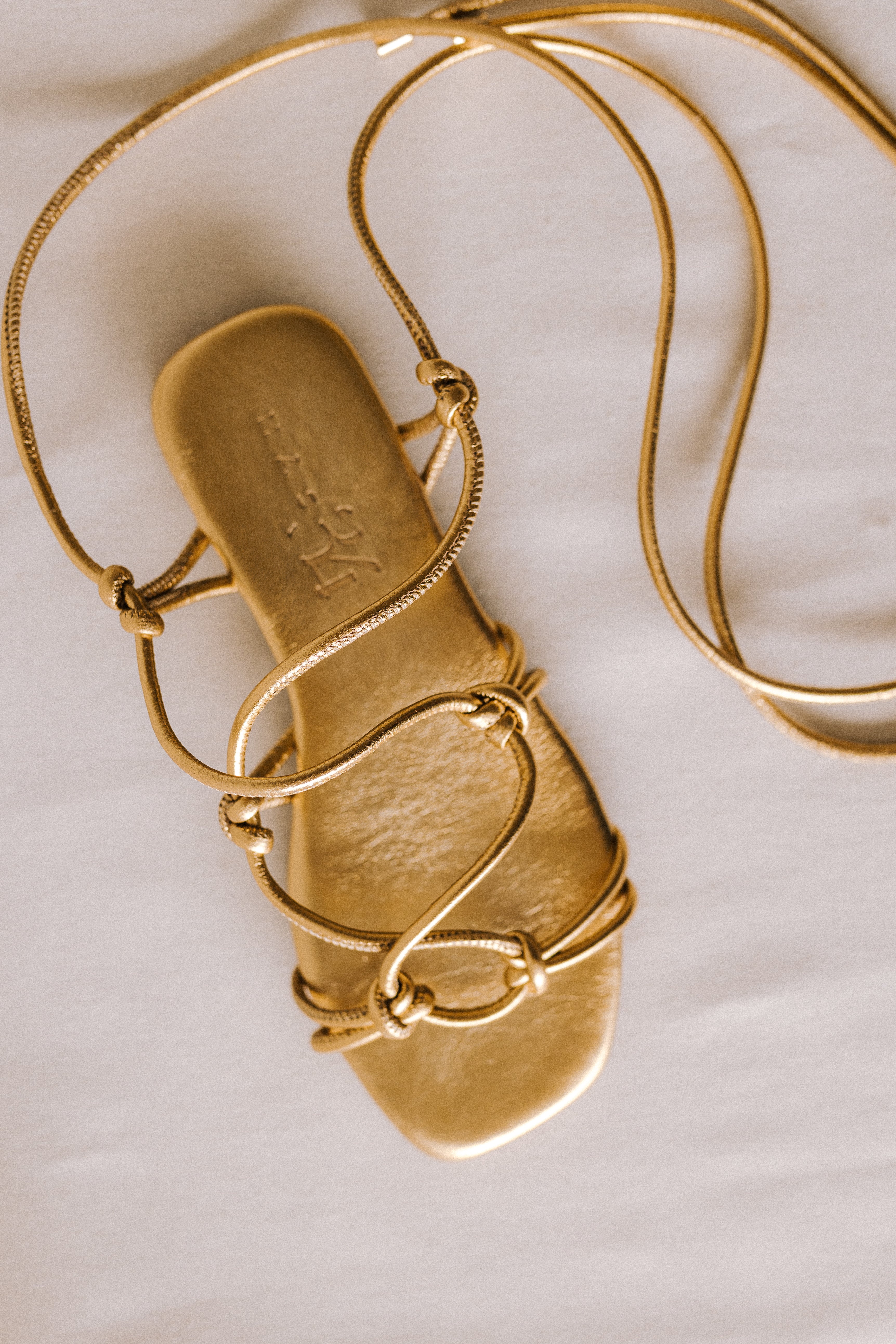 CATY FLAT SANDAL IN GOLD LAMINATED LEATHER