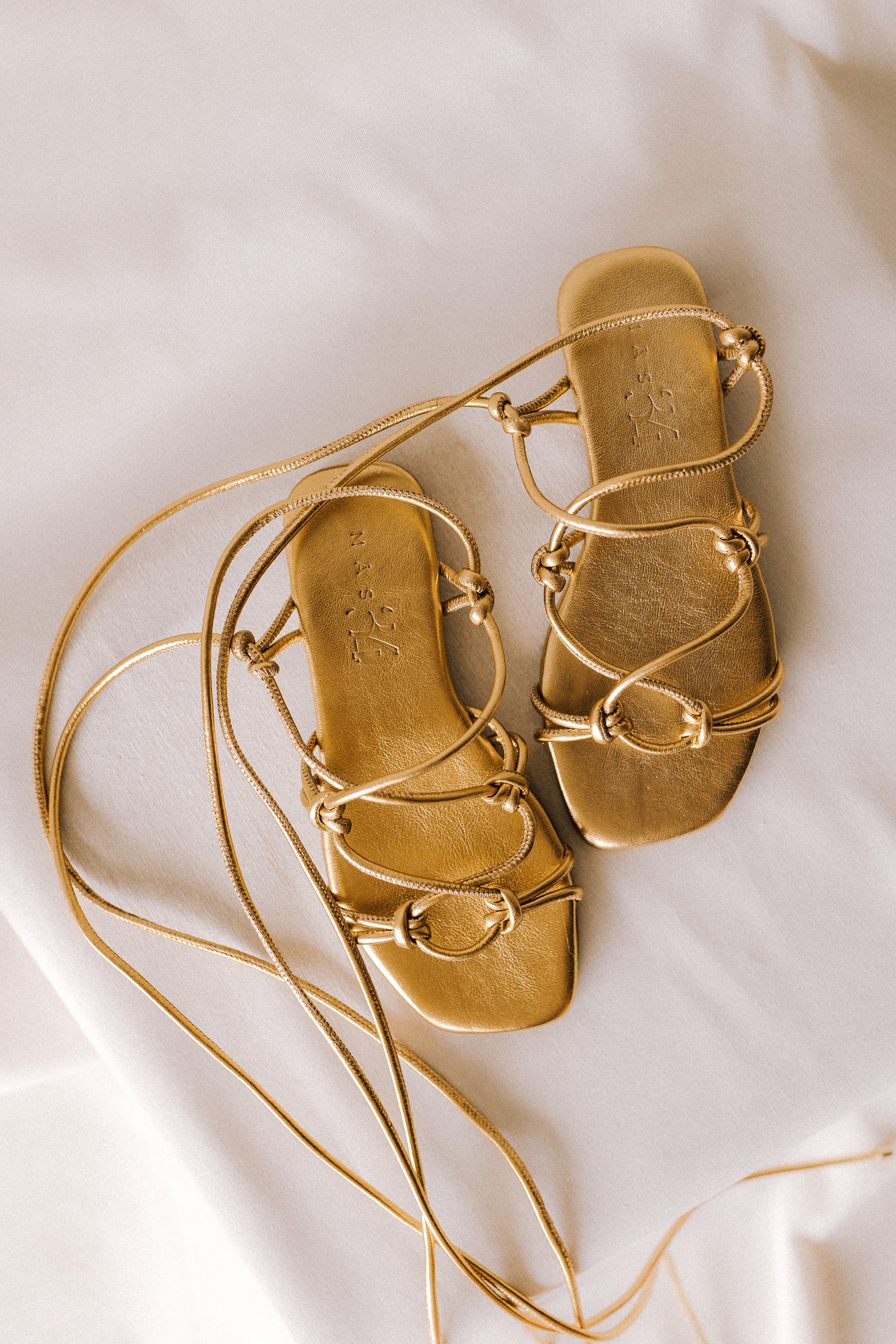 CATY FLAT SANDAL IN GOLD LAMINATED LEATHER