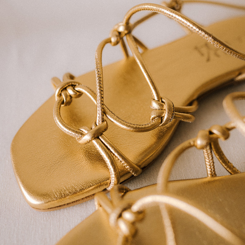 CATY FLAT SANDAL IN GOLD LAMINATED LEATHER