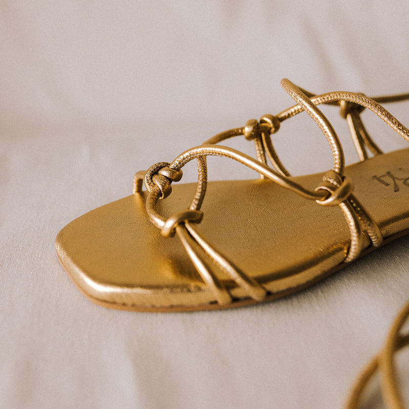 CATY FLAT SANDAL IN GOLD LAMINATED LEATHER