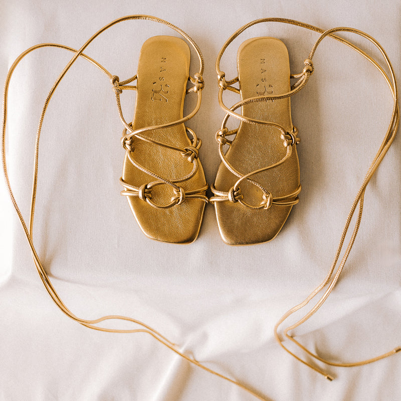 CATY FLAT SANDAL IN GOLD LAMINATED LEATHER