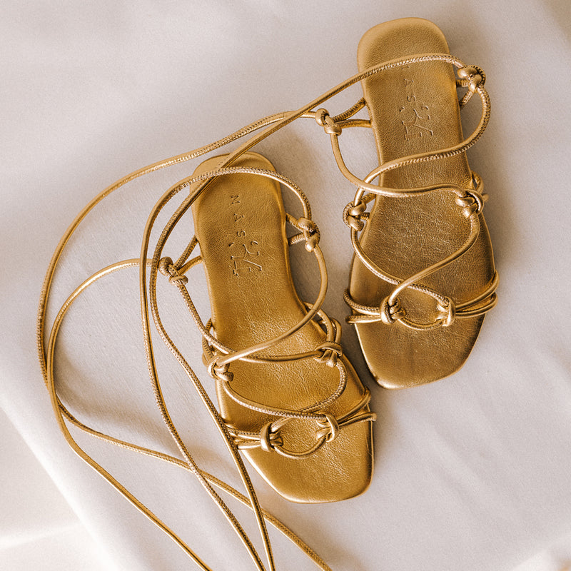 CATY FLAT SANDAL IN GOLD LAMINATED LEATHER