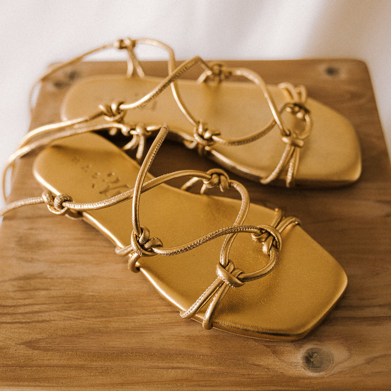 CATY FLAT SANDAL IN GOLD LAMINATED LEATHER