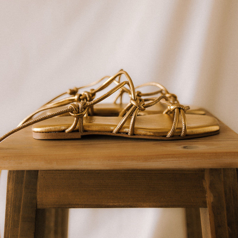 CATY FLAT SANDAL IN GOLD LAMINATED LEATHER